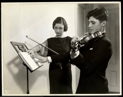 Woman teaching a blind young man to play the violin at the New York Association for the Blind, 111 East 59th Street, New York, 1936 by Byron Company